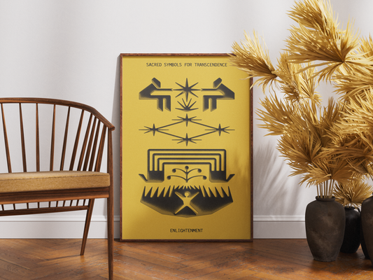 A framed art print featuring black sacred geometry and symbolic designs on a mustard yellow background, leaning against a white wall on a wooden floor next to a wooden chair and dried palm branches in dark vases.